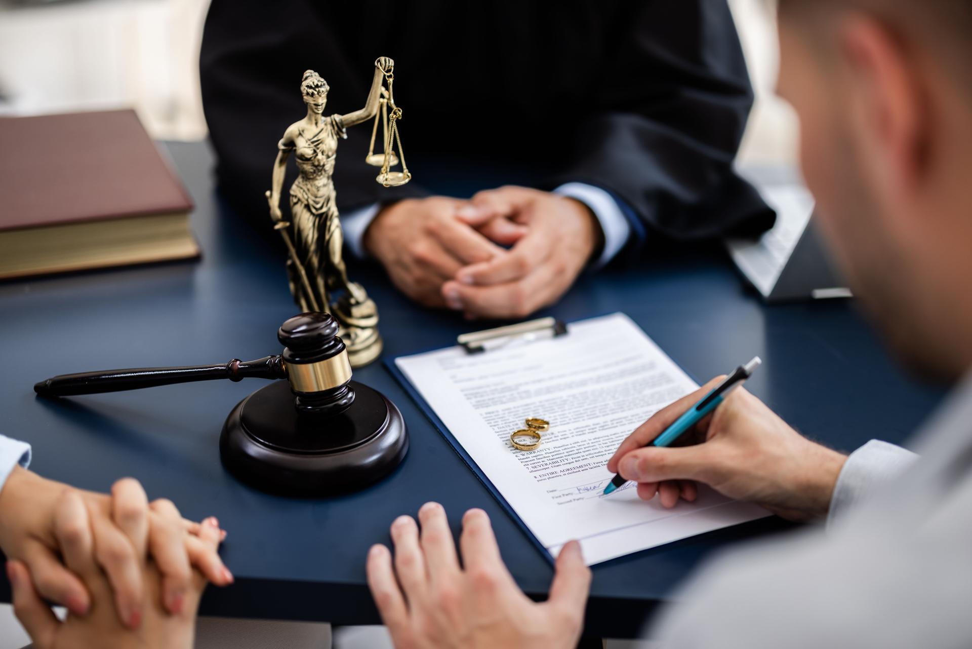 Young couple, one Caucasian and one Hispanic, consulting with a lawyer in court